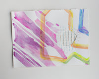 An abstract watercolor painting of flowers on paper.