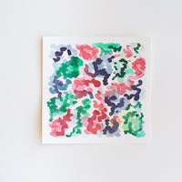 An abstract watercolor painting of flowers on paper.