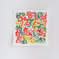 An abstract watercolor painting of flowers on paper.