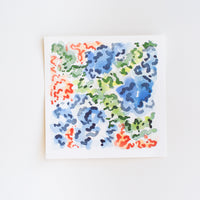 An abstract watercolor painting of flowers on paper.