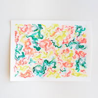 An abstract watercolor painting of flowers on paper.