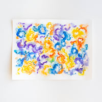 An abstract watercolor painting of flowers on paper.