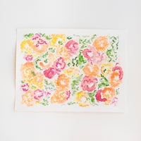 An abstract watercolor painting of flowers on paper.