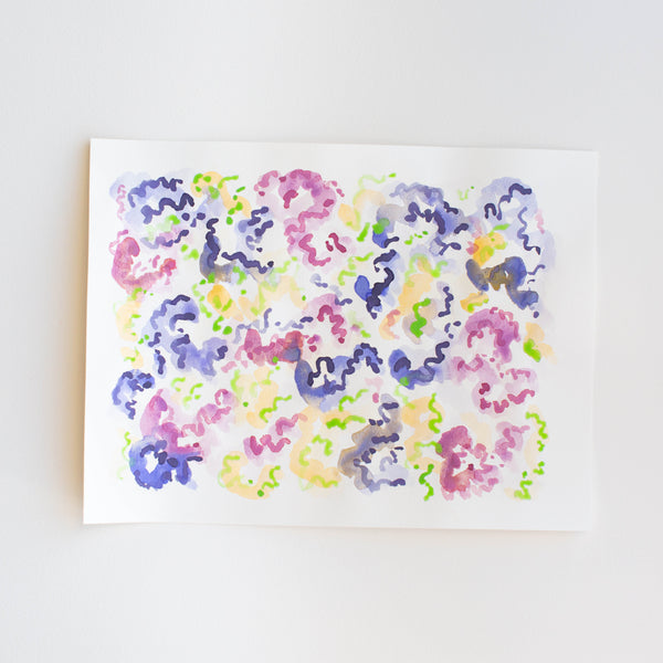 An abstract watercolor painting of flowers on paper.
